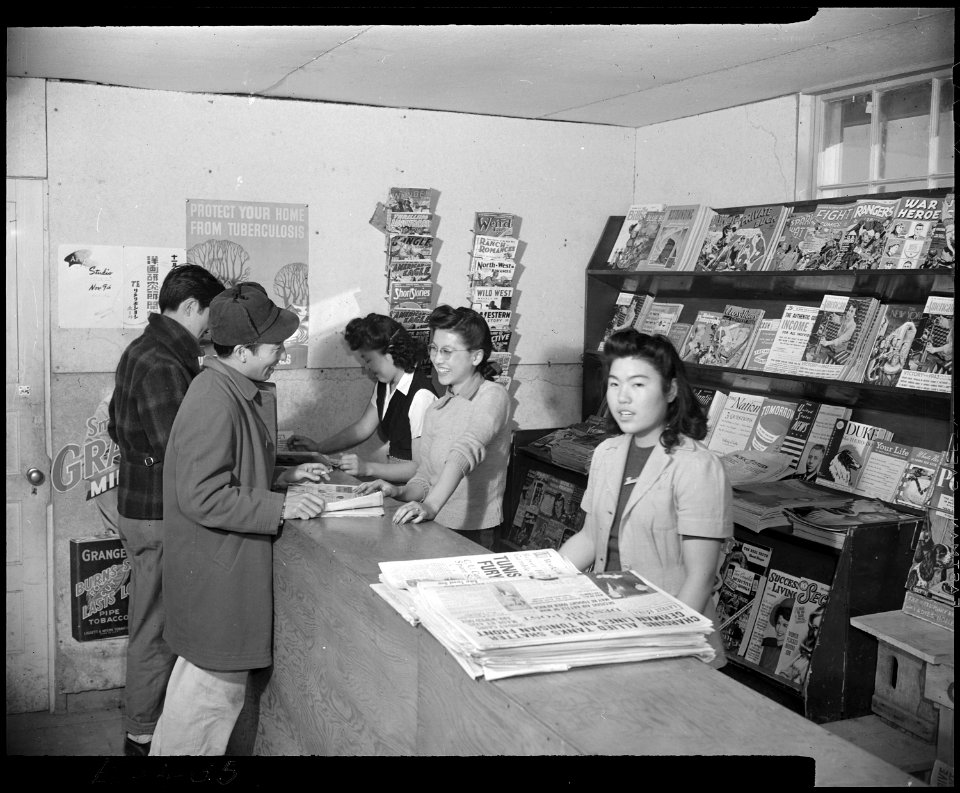 Granada Relocation Center, Amache, Colorado. The magazine counter at one of the cooperative stores . . . - NARA - 539012