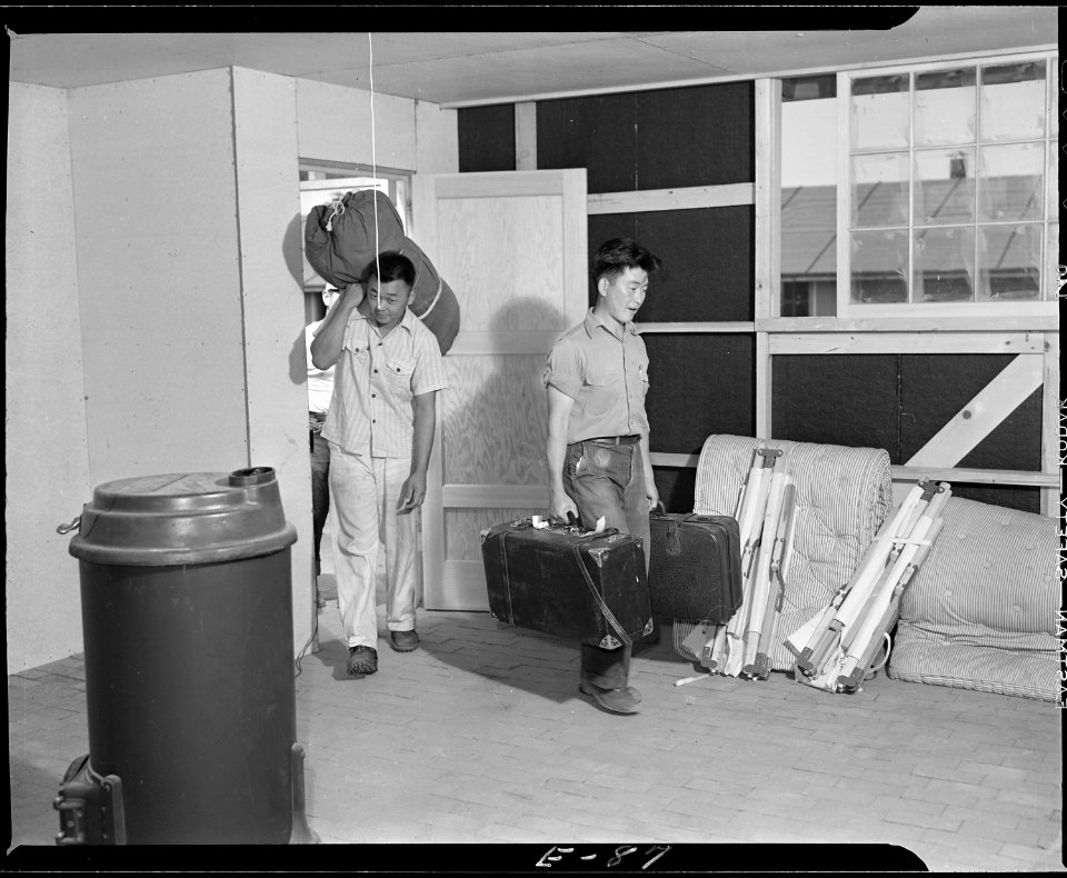 Granada Relocation Center, Amache, Colorado. Young evacuees carrying their personal belongings into . . . - NARA - 538750