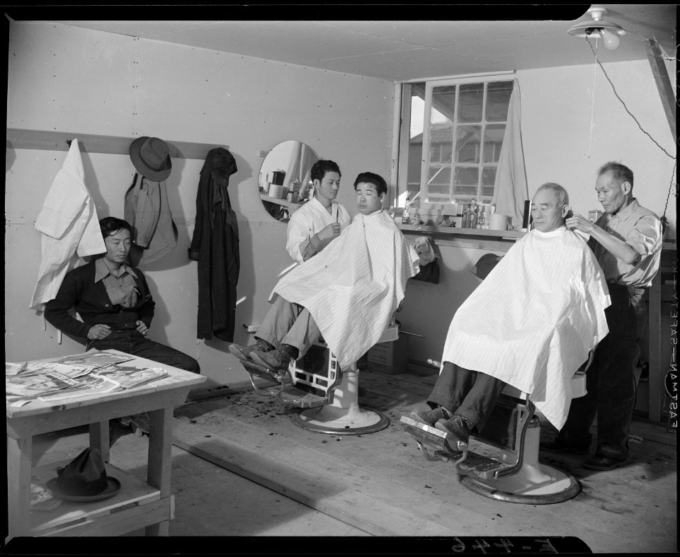 Granada Relocation Center, Amache, Colorado. With a total of three chairs, the cooperative barber s . . . - NARA - 539019