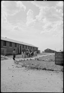 Granada Relocation Center, Amache, Colorado. View showing Elementary children landscaping the groun . . . - NARA - 539393