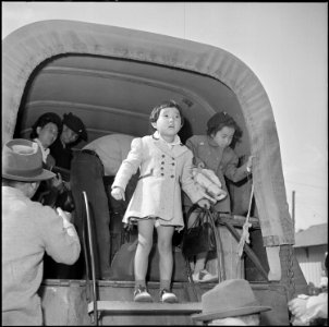 Granada Relocation Center, Amache, Colorado. Two little girls are shown descending from one of the . . . - NARA - 539906