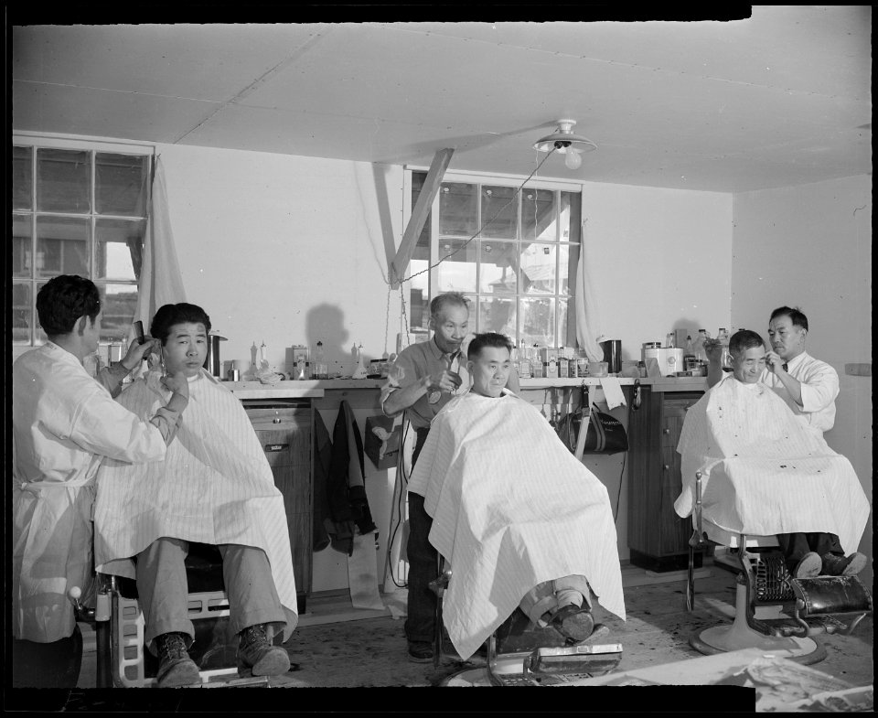 Granada Relocation Center, Amache, Colorado. With a total of three chairs, the cooperative barber s . . . - NARA - 539020