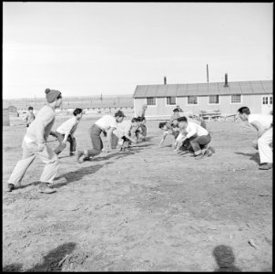 Granada Relocation Center, Amache, Colorado. Young center Niseis are football enthusiasts. Here du . . . - NARA - 539101
