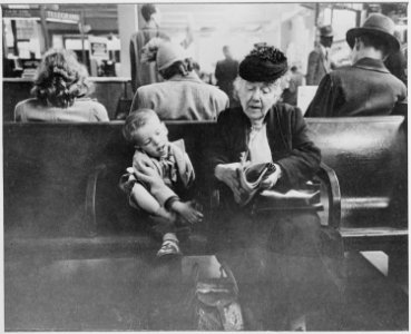 Grandmother amusing her young companion in the waiting room of the Greyhound Bus Station, New York City, 07-1947 - NARA - 541942