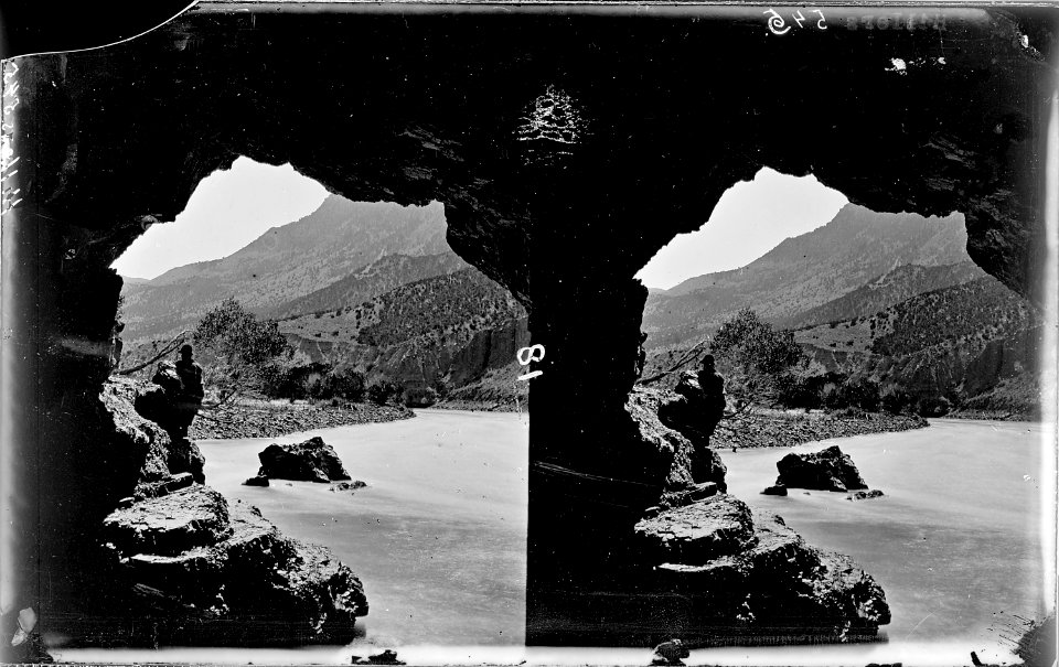 Green River. Split Mountain Canyon. Small cave, looking out. A man is looking out in left shadow of - NARA - 517864