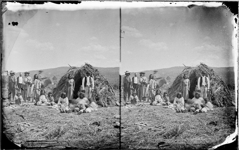 Group of Apaches in front of their wick-8-ups near Camp Apache, Arizona 1873 - NARA - 519783
