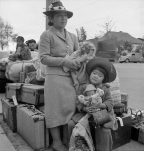Hayward, California. These people of Japanese ancestry are awaiting the special bus which will take . . . - NARA - 537522 photo