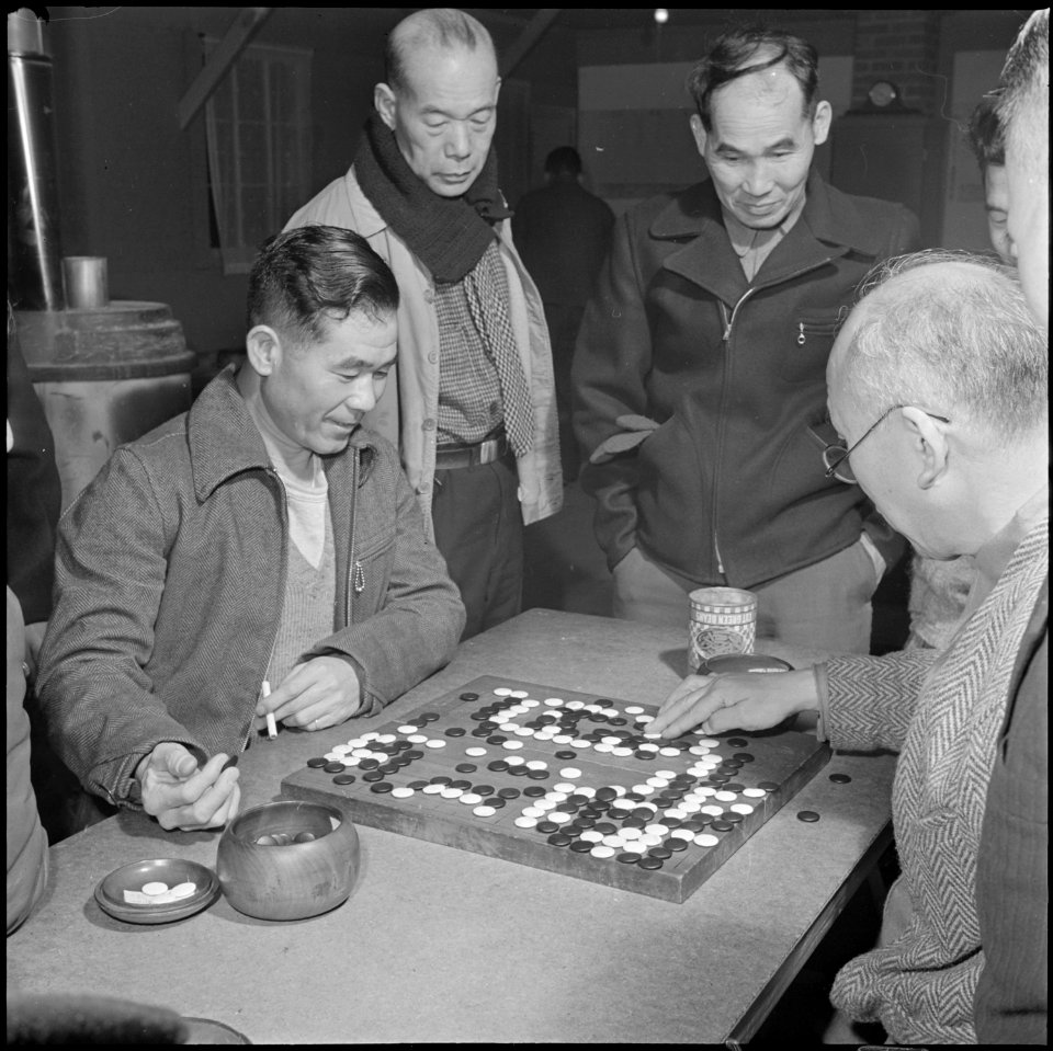 Heart Mountain Relocation Center, Heart Mountain, Wyoming. A group of centerites gather around two . . . - NARA - 539158