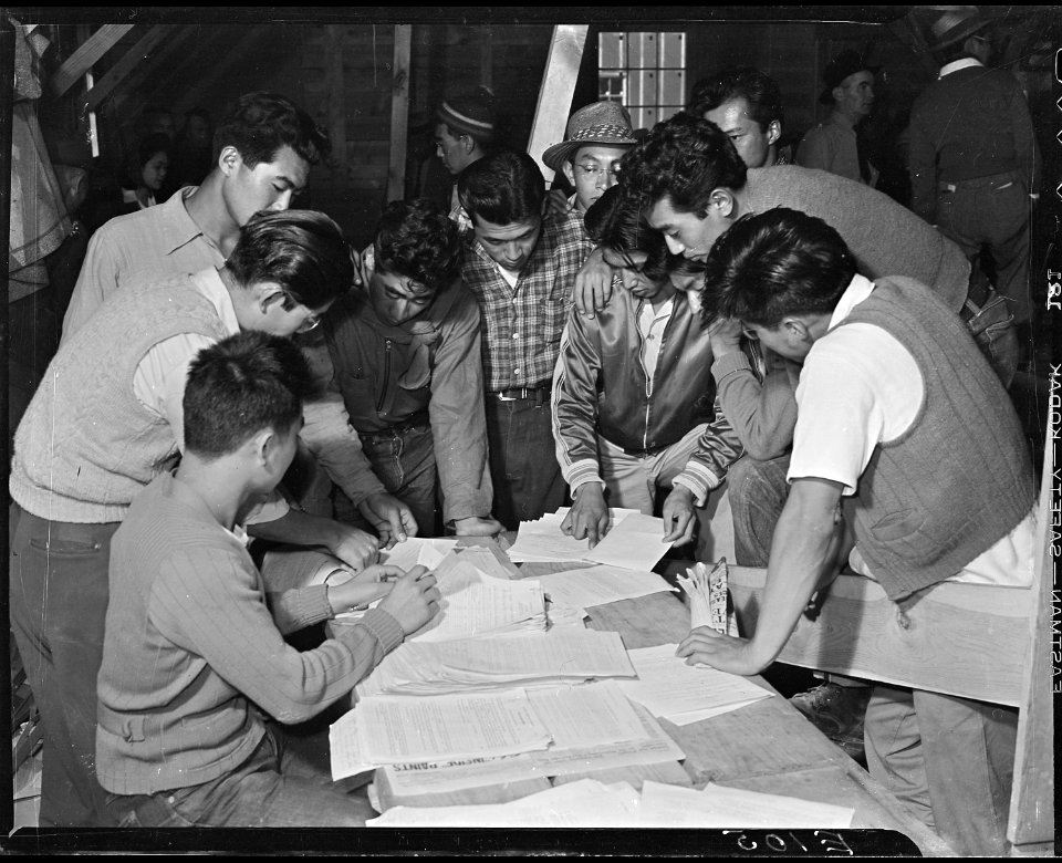 Heart Mountain Relocation Center, Heart Mountain, Wyoming. A group of volunteer beet workers look o . . . - NARA - 538768