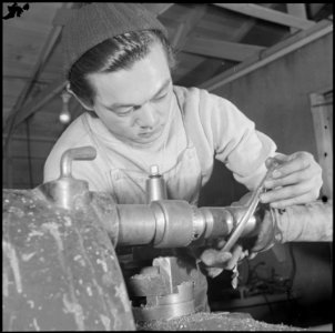 Heart Mountain Relocation Center, Heart Mountain, Wyoming. A young Nisei machinist reparing a truck . . . - NARA - 539253
