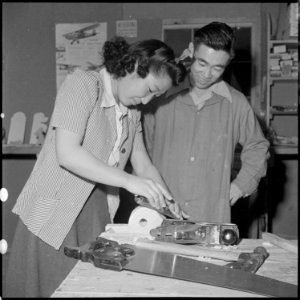 Heart Mountain Relocation Center, Heart Mountain, Wyoming. As the instructor looks on, a young Nise . . . - NARA - 539227