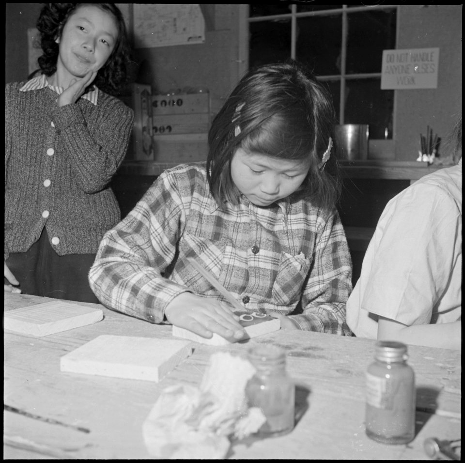 Heart Mountain Relocation Center, Heart Mountain, Wyoming. A young enthusiast working on a pair of . . . - NARA - 539232