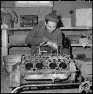 Heart Mountain Relocation Center, Heart Mountain, Wyoming. A young mechanic of Japanese ancestry, a . . . - NARA - 539241