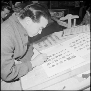 Heart Mountain Relocation Center, Heart Mountain, Wyoming. A young artists in the Poster Shop at th . . . - NARA - 539151