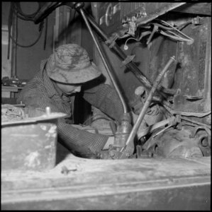 Heart Mountain Relocation Center, Heart Mountain, Wyoming. A young mechanic of Japanese ancestry re . . . - NARA - 539242