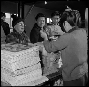 Heart Mountain Relocation Center, Heart Mountain, Wyoming. Customers line up at the counter as the . . . - NARA - 539197