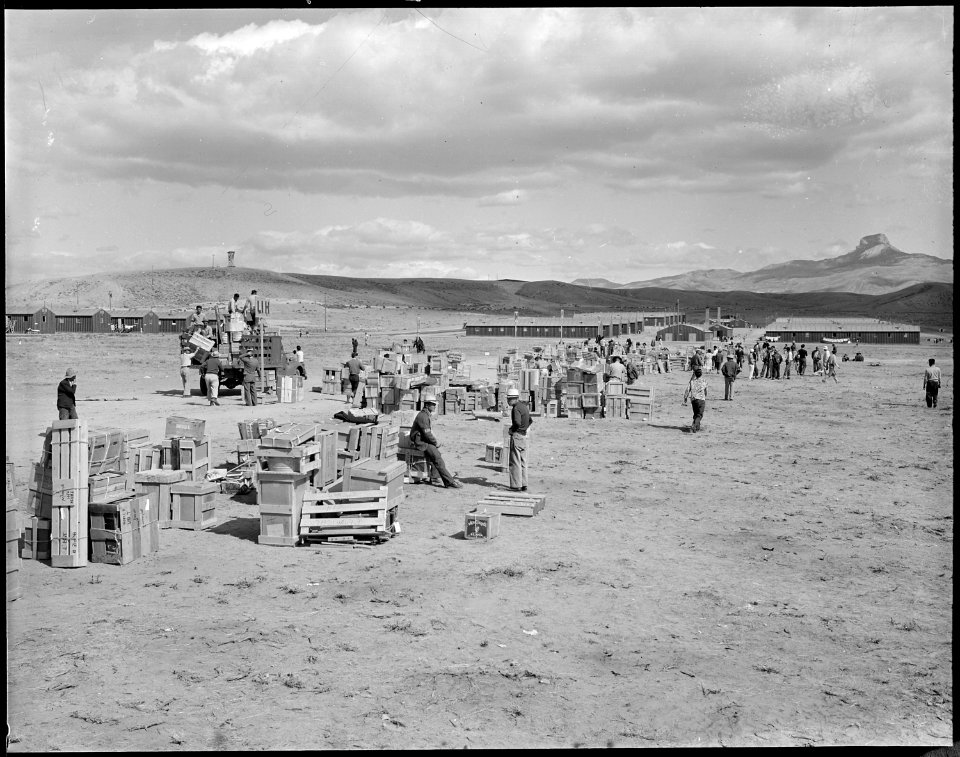 Heart Mountain Relocation Center, Heart Mountain, Wyoming. Crates of personal belongings are sorted . . . - NARA - 538780