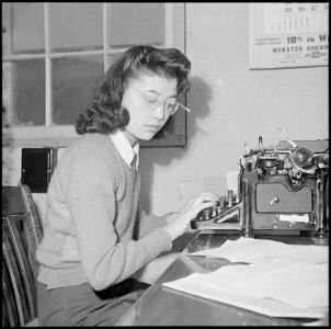 Heart Mountain Relocation Center, Heart Mountain, Wyoming. Reporter Kay Masuda of the Sentinel staf . . . - NARA - 539148