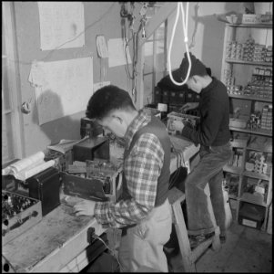 Heart Mountain Relocation Center, Heart Mountain, Wyoming. Young raido repairmen in the radio shop . . . - NARA - 539212