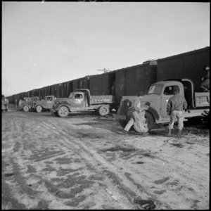 Heart Mountain Relocation Center, Heart Mountain, Wyoming. Trucks line up at the coal cars on the s . . . - NARA - 539243