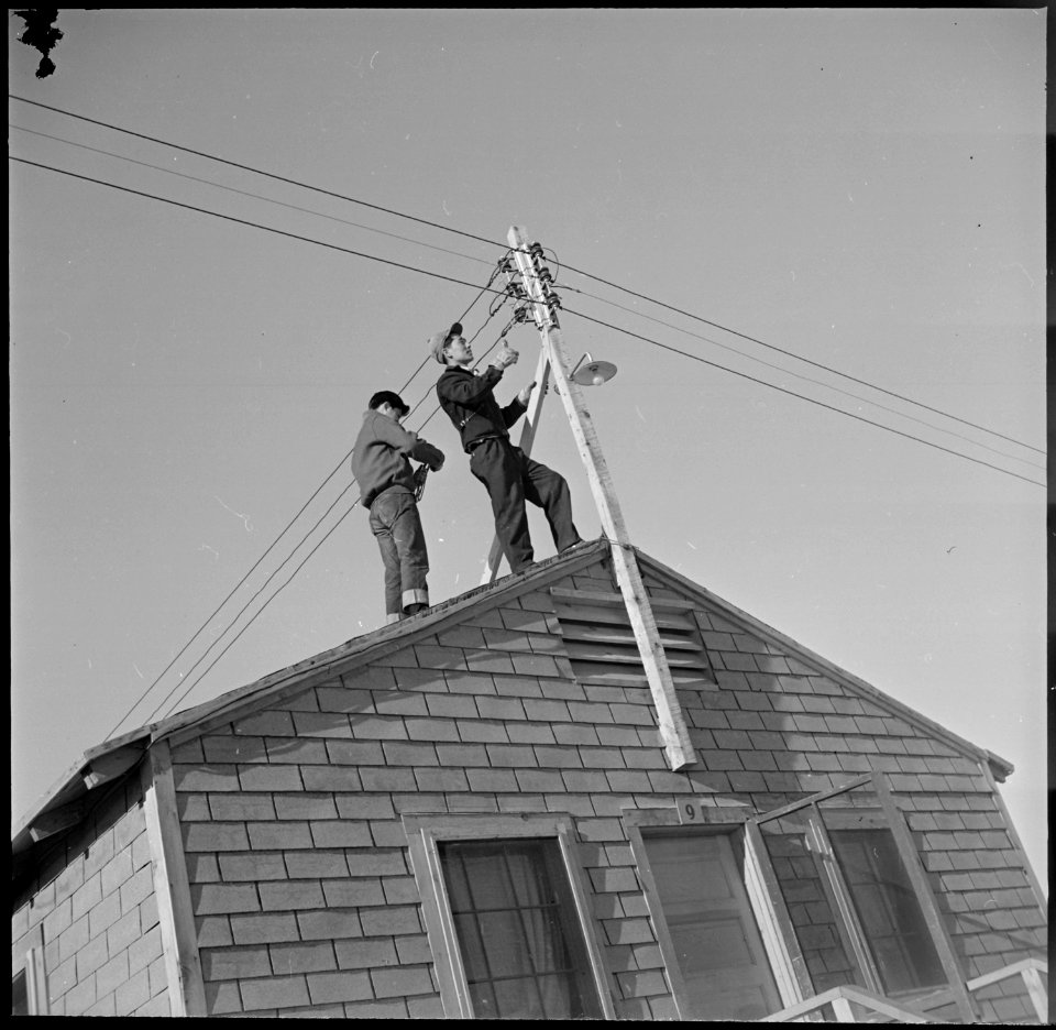 Heart Mountain Relocation Center, Heart Mountain, Wyoming. Two center electricians repair wires sli . . . - NARA - 539225