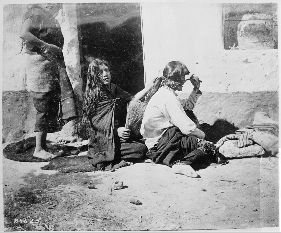 Hopi man having hair dressed by his squaw - NARA - 530948
