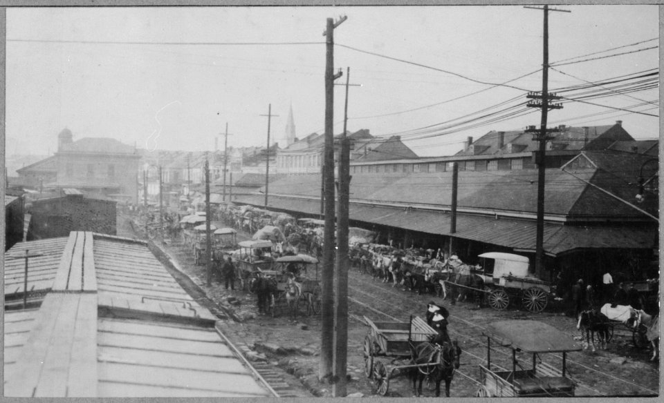 Horse-drawn wagons line the narrow street in front of New Orleans' French Market, 01-1915 - NARA - 521050