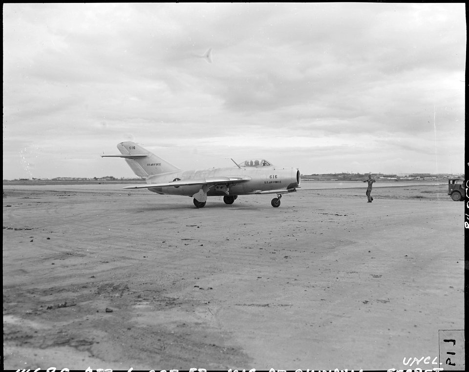 HQ. FEAF, TOKYO - With reassembly and ground checks completed, the MIG is taxiied to take-off position by a U.S.... - NARA - 542267