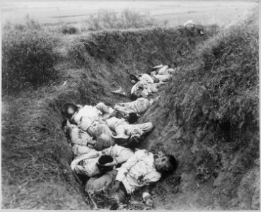 Insurgent dead just as they fell in the trench near Santa Ana, February 5th. The trench was circular, and the picture sh - NARA - 524389