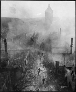 Infantrymen of the 255th Infantry Regiment. move down a street in Waldenburg to hunt out the Hun after a recent raid... - NARA - 531283 photo