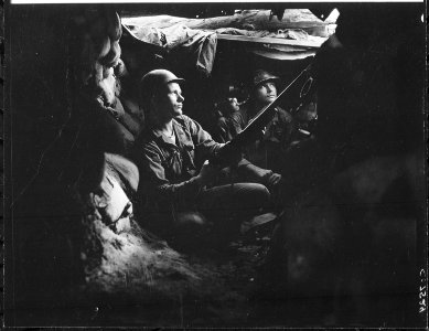 Infantrymen of the 27th Infantry Regiment, near Heartbreak Ridge, take advantage of cover and concealment in tunnel... - NARA - 531428 photo