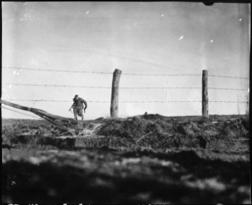 Infantryman goes out on a one-man sortie, covered by a buddy in the background. 82nd Airborne Division, Bra, Belgium. - NARA - 531233 photo