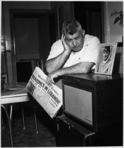 James Thaber, born in Lebanon, of Mount Clemens, Missouri, listens to President Eisenhower's broadcast of his decision t - NARA - 542081