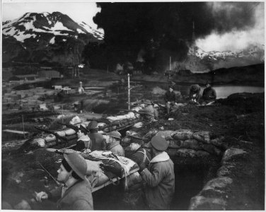 Japanese attack on Dutch Harbor, June 3, 1942. Group of Marines on the alert between attacks. Smoke from burning... - NARA - 520589