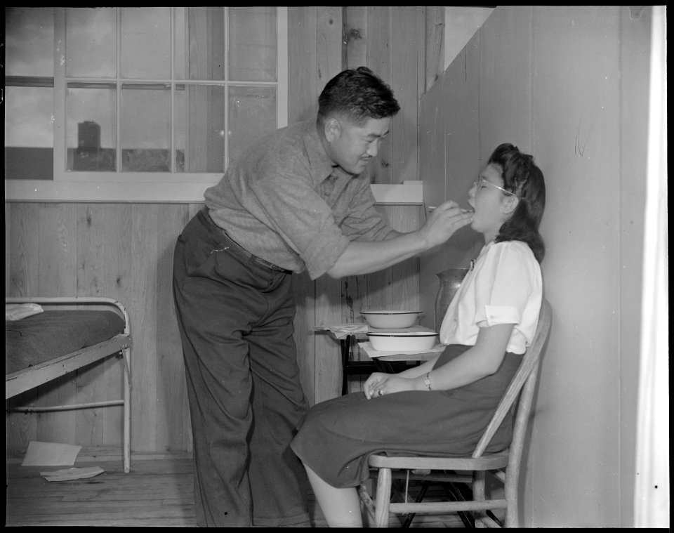 Jerome Relocation Center, Denson, Arkansas. A patient with a toothache being examined in a temporar . . . - NARA - 538885