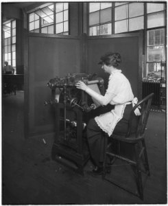 Intaglio web perforating machine for stamps. (Woman working) - NARA - 532293 photo