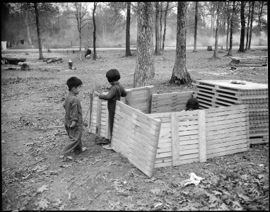 Jerome Relocation Center, Denson, Arkansas. Children playing house in a makeshift play house. - NARA - 538867
