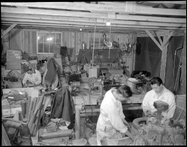 Jerome Relocation Center, Denson, Arkansas. Attending to details in motor repair at the temporary garage. - NARA - 538994