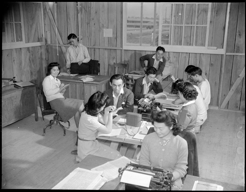 Jerome Relocation Center, Denson, Arkansas. Evacuees on the newspaper staff at work in their office. - NARA - 538991