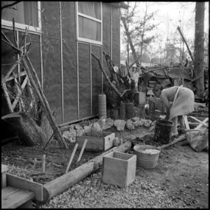 Jerome Relocation Center, Denson, Arkansas. Mrs. T. Arima busily prepares her doorstep garden in Bl . . . - NARA - 538835