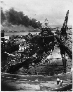 Japanese attack on Pearl Harbor. Wrecked USS DOWNES at left and USS CASSIN at right. In the rear is the USS... - NARA - 520593