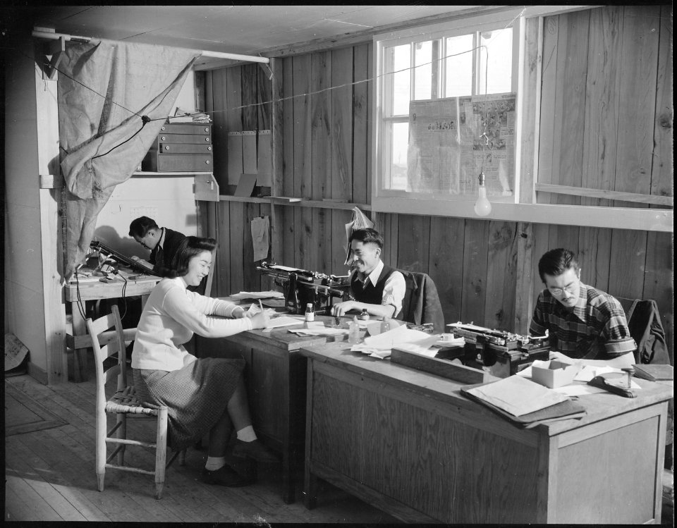 Jerome Relocation Center, Denson, Arkansas. Part of the newspaper staff at work in the Communique Office. - NARA - 538990