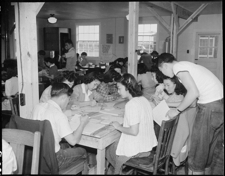 Jerome Relocation Center, Denson, Arkansas. The evacuees grouped around this table are part of the . . . - NARA - 538875