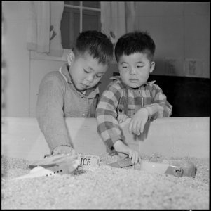 Jerome Relocation Center, Denson, Arkansas. Two young pre-school students play in the sand box at t . . . - NARA - 539326