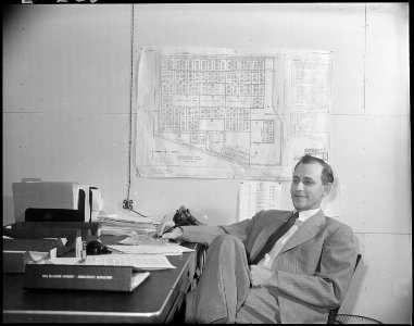 Jerome Relocation Center, Denson, Arkansas. Paul A.Taylor, Project Director seated casually at his desk. - NARA - 538859