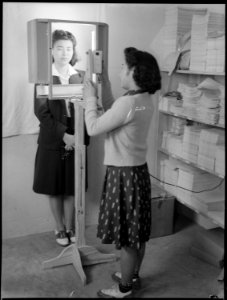 Jerome Relocation Center, Dermott, Arkansas. Dorothy Maruki having her identification picture taken . . . - NARA - 537299