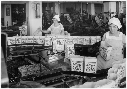 Kellogg Company. Women inspecting filled boxes of cereal before boxes go to sealer. - NARA - 522864 photo