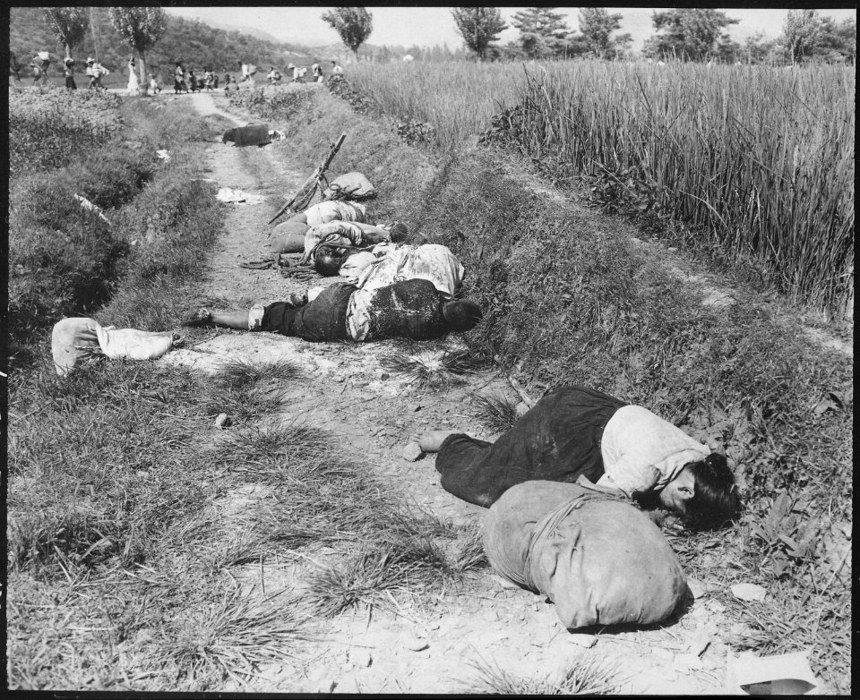 Korean civilians fleeing from the North Korean forces, killed when caught in the line of fire during night attack by... - NARA - 531369