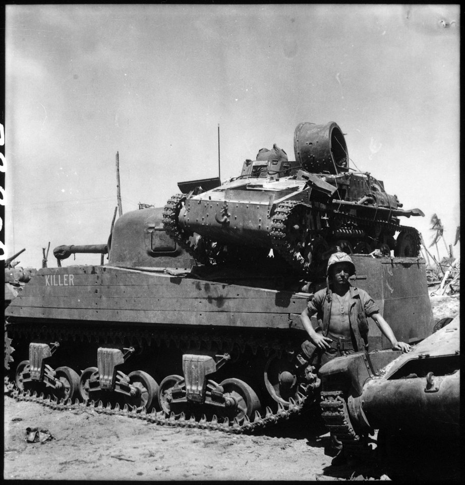 Kwajalein Atoll. Private First Class N. E. Carling stands beside the medium tank Killer on which is mounted a dead... - NARA - 532524