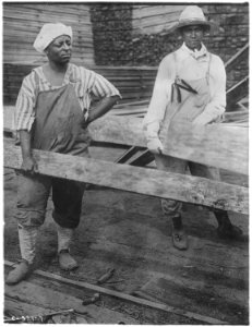 Labor. (African-American) women at work in lumber yards. (African-American) women, dressed in men's clothes, lifting... - NARA - 522867 photo